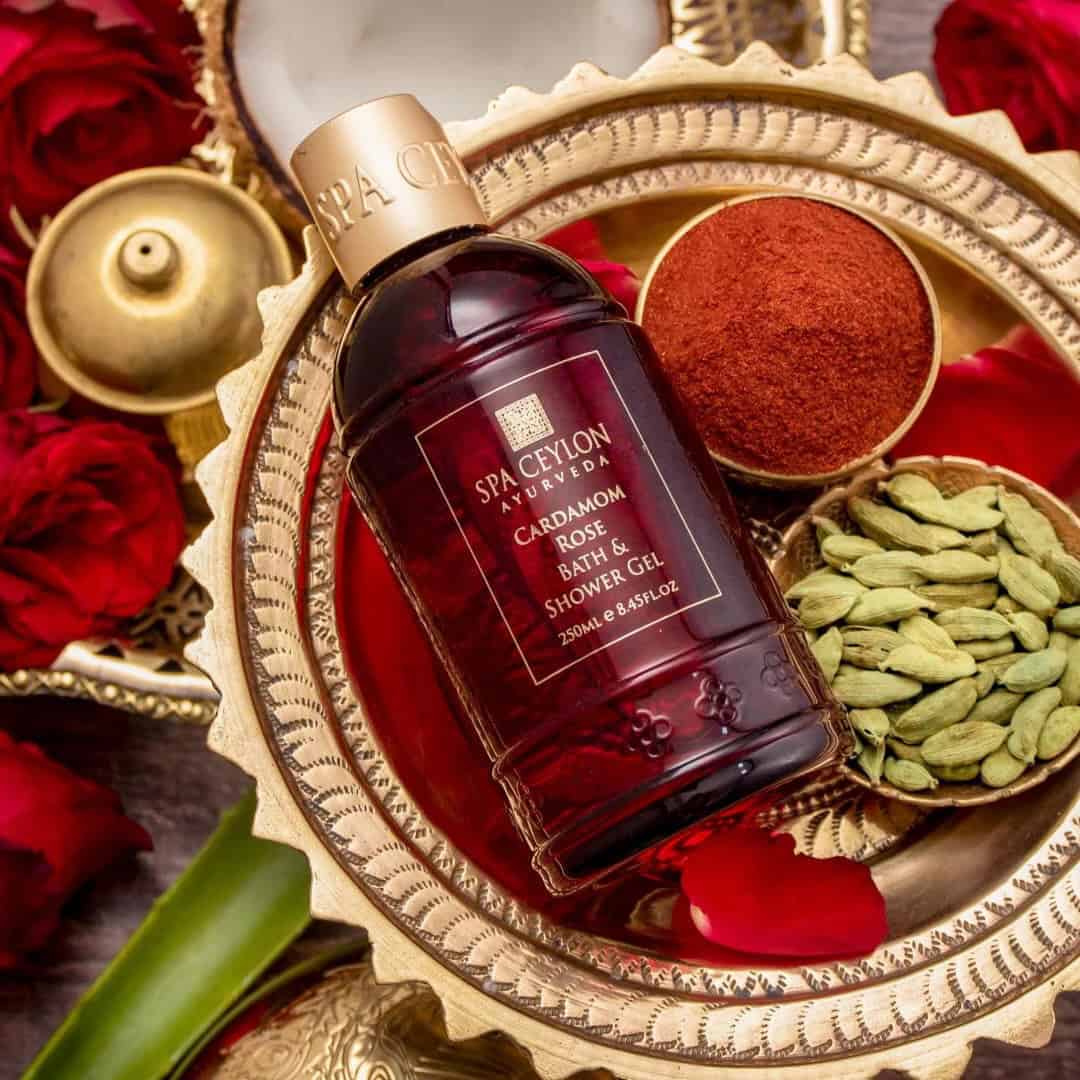 Lavender-brown Cardamom Rose Bath & Shower Gel from Spa Ceylon Ayurveda, with spices and dried herbs, in an ornate setting.