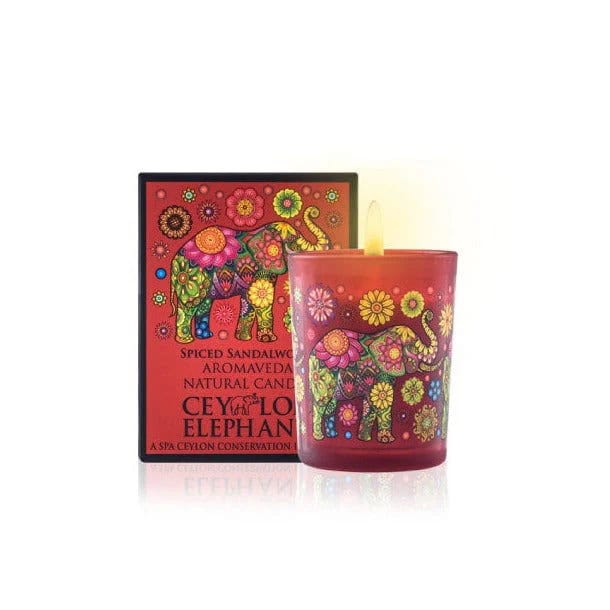 Votive candle with colorful elephant design and floral patterns for Spa Ceylon aromatherapy products.