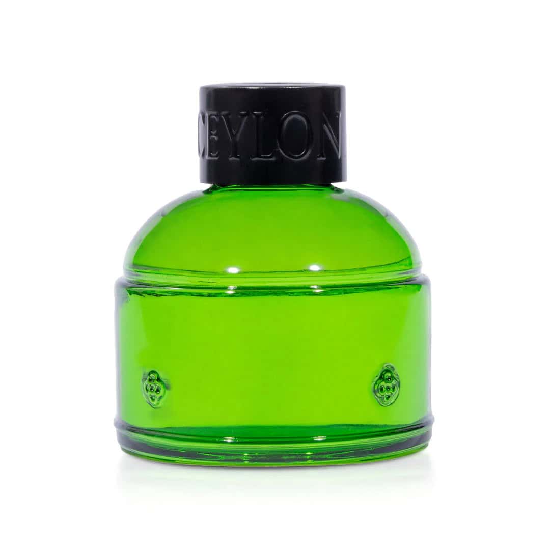 Vibrant green Spa Ceylon fragrance bottle with black cap, luxury aromatic perfume.