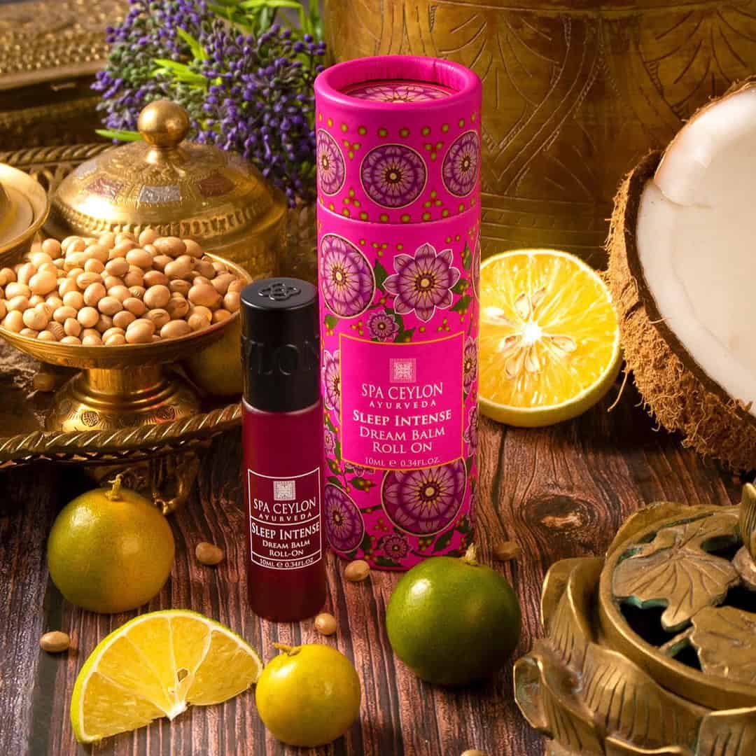 Vibrant Spa Ceylon Ayurveda Sleep Intense Dream Balm Roll-On with tropical fruits and traditional decor.