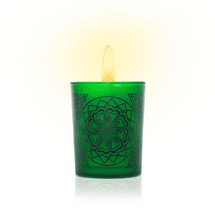Hand-poured green scented candle with intricate floral design for relaxation and wellness.