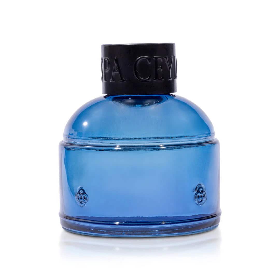 Blue glass perfume bottle from Spa Ceylon, luxury fragrance collection.